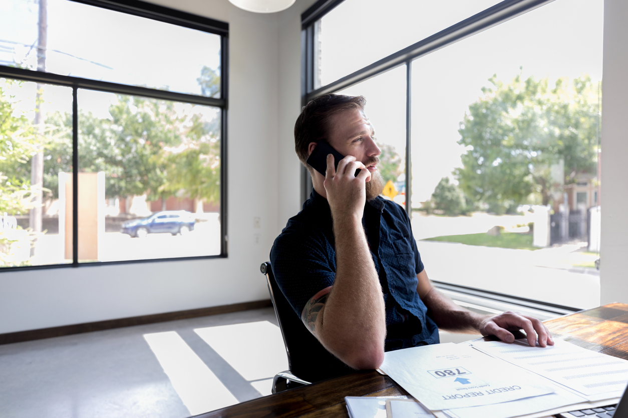 An up-close shot of a businessman calling to verify a credit inquiry to begin a removal letter if neccessary.